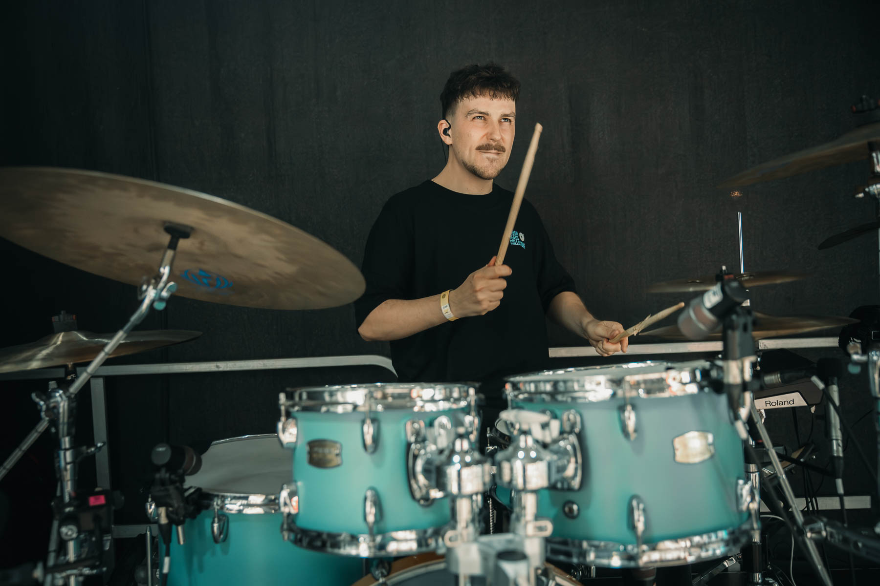 Julian Feuchter playing his turquoise drum kit on stage