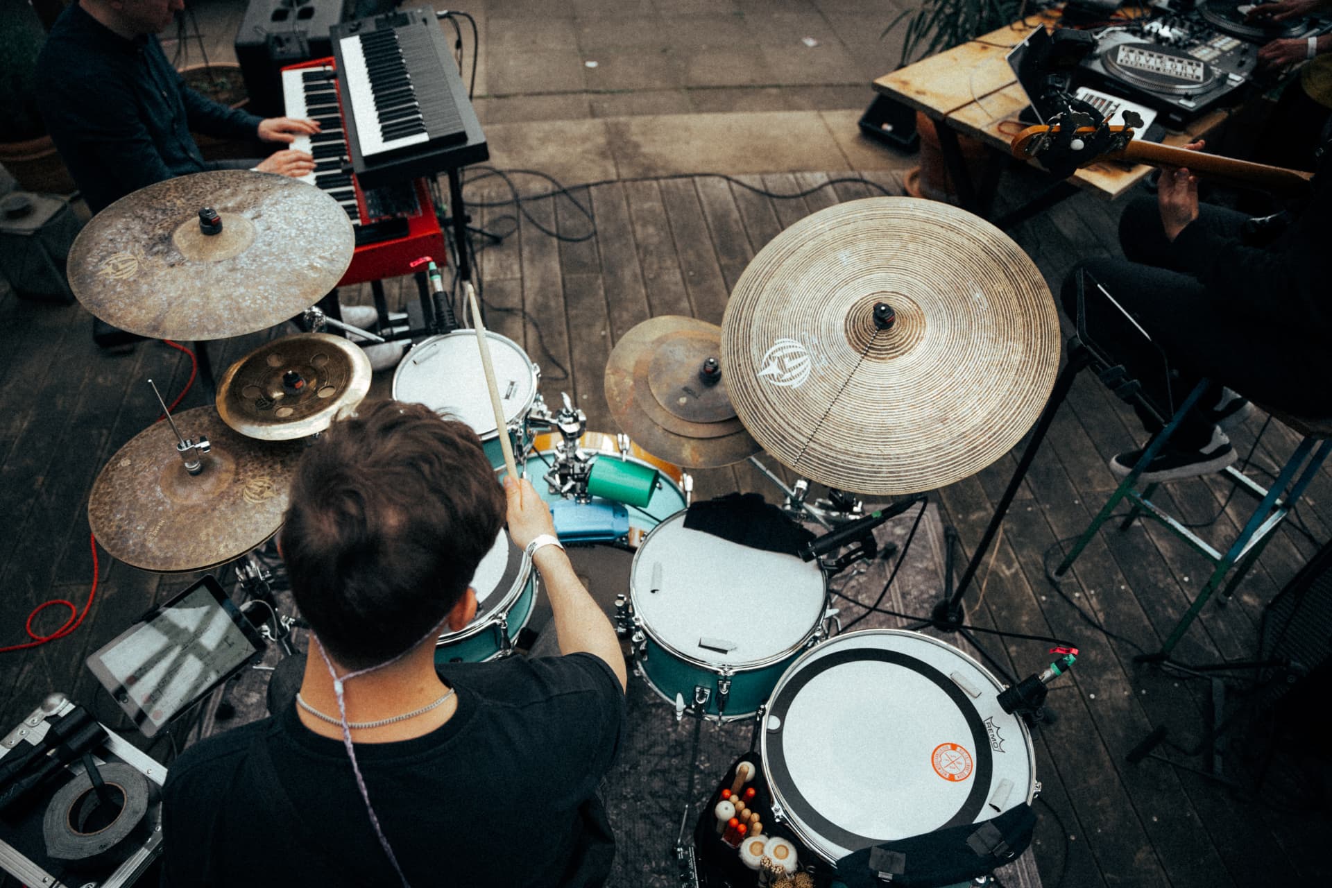 Overhead view of Julian Feuchter playing drums with keys and bass beside him